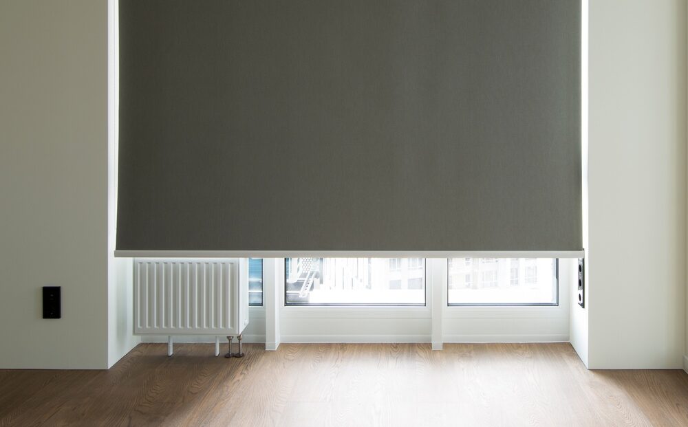 Roller Blinds Closeup On The Window In The Interior. Blackout Roller Shades For Big Windows